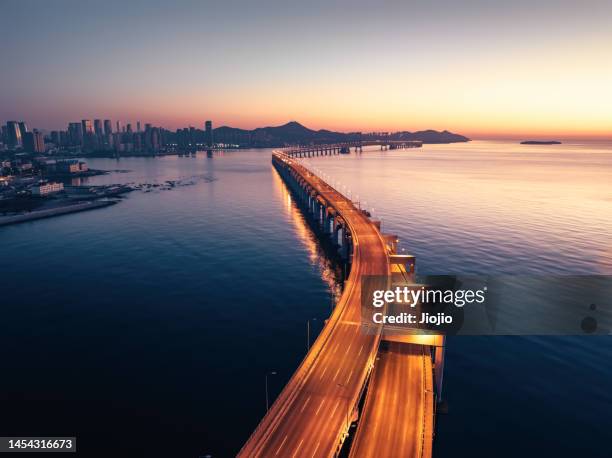 cross-sea bridge - winding road night stock pictures, royalty-free photos & images