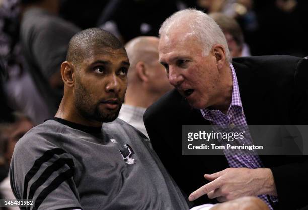 Head coach Gregg Popovich of the San Antonio Spurs talks to Tim Duncan on the bench in the third quarter while taking on the Oklahoma City Thunder in...