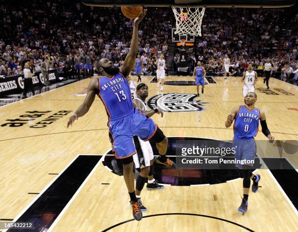 James Harden of the Oklahoma City Thunder lays the ball up in front of Stephen Jackson of the San Antonio Spurs in the second half in Game Two of the...