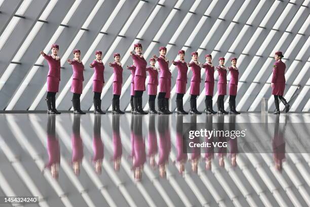 High-speed train attendants participate in a customer service training session at a railway station ahead of the Spring Festival travel rush on...