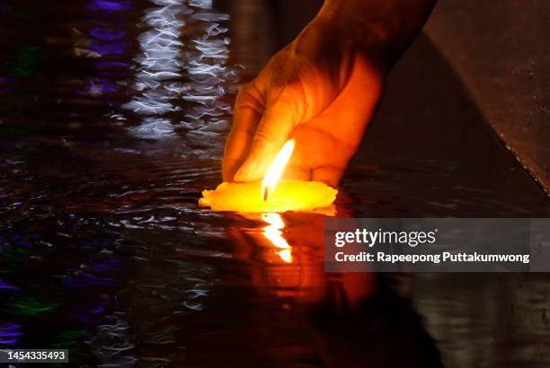 spiritual inspirational candle light burning floating in the water - candle flame stock pictures, royalty-free photos & images