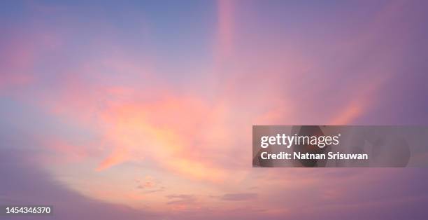 fluffy orange clouds at sunset - elysium photos et images de collection