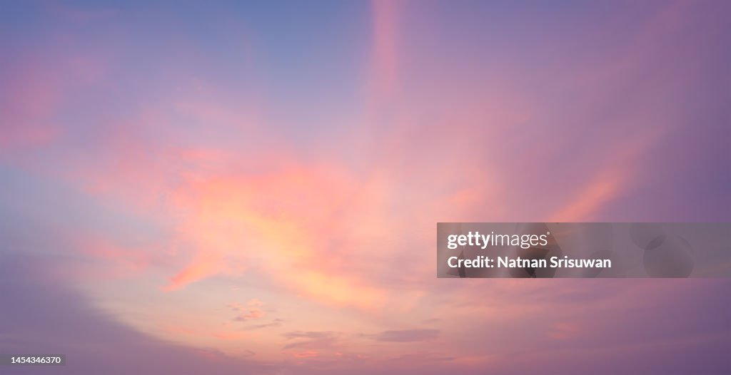Fluffy orange clouds at sunset