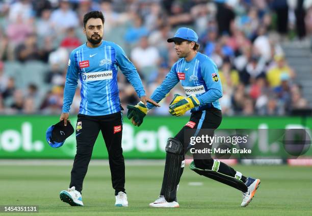 Rashid Khan of the Strikers after bowling his last ball with Harry Nielsen of the Strikers during the Men's Big Bash League match between the...