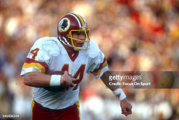 Washington, D.C. Running back John Riggins of the Washington Redskins carries the ball during an NFL football game circa 1981 at RFK Stadium in...