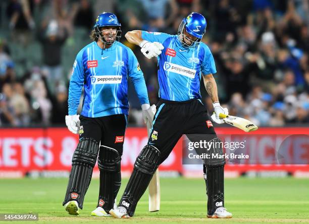 Matt Short of the Strikers celebrates hitting the winning runs with Colin De Grandhomme of the Strikers during the Men's Big Bash League match...