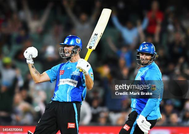 Matt Short of the Strikers celebrates hitting the winning runs with Colin De Grandhomme of the Strikers during the Men's Big Bash League match...