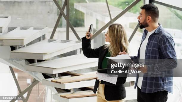 two architects inspecting and taking pictures of construction site - employee engagement survey stock pictures, royalty-free photos & images