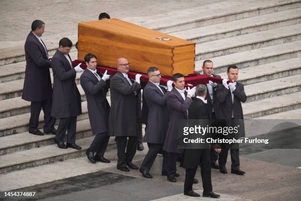 Pallbearers carry the coffin of Pope Emeritus Benedict XVI at the start of his funeral mass at St. Peter's square on January 5, 2023 in Vatican City,...