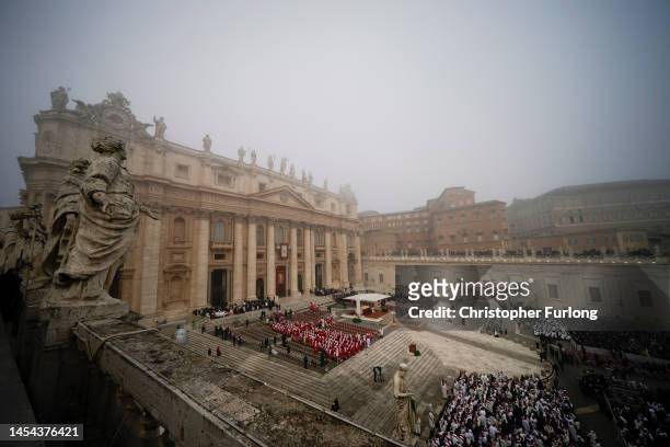 People arrive in the morning mist for the funeral of Pope Emeritus Benedict XVI on January 5, 2023 in Vatican City, Vatican. Former Pope Benedict...