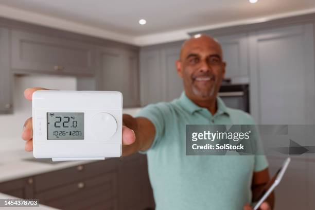 smart home thermostat - fuel efficiency stock pictures, royalty-free photos & images