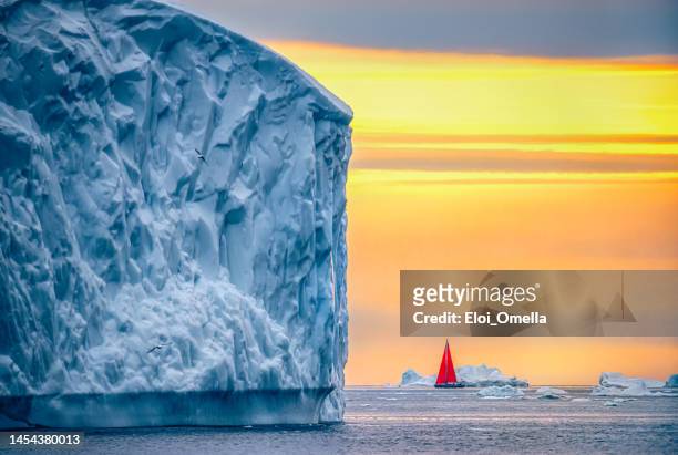 beautiful landscape with large icebergs and red boat - midnight sun stock pictures, royalty-free photos & images