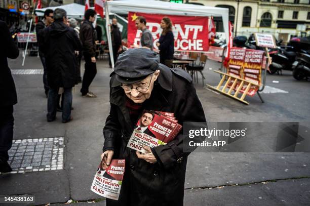 Militant of the French Front de Gauche leftist party distributes tracts for the FG candidate for the 2012 French presidential election on April 13 in...