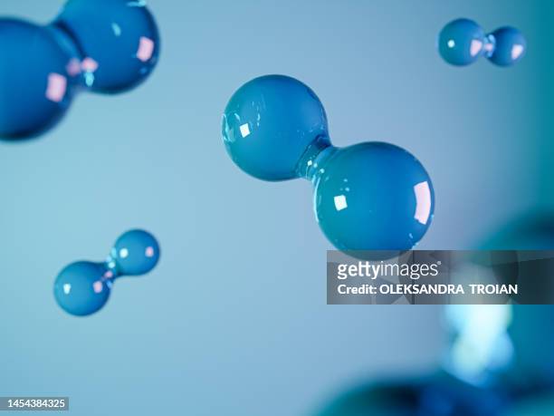 hydrogen molecule on blue background. 3d render of green fuel - átomo fotografías e imágenes de stock