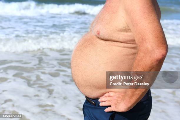 obese man on beach - fat guy on beach fotografías e imágenes de stock