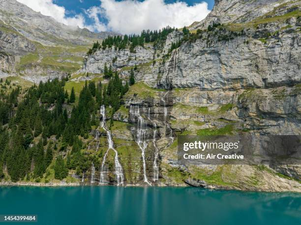 aerial view of oeschinen lake waterfalls, switzerland - lac-oeschinensee photos et images de collection