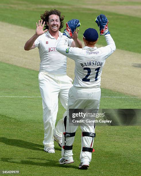 Ryan Sidebottom of Yorkshire celebrates with Jonathan Bairstow dismissing Kyle Coetzer of Northamptonshire during day one of the LV County...