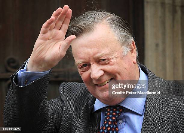 Justice Secretary Ken Clarke waves to photographers as he arrives at The Royal Courts of Justice give evidence to The Leveson Inquiry on May 30, 2012...