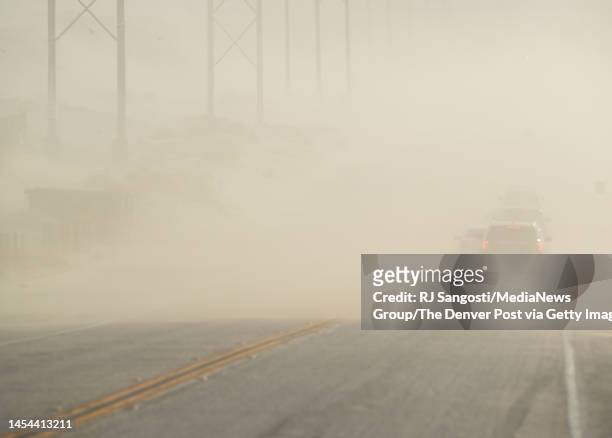 Dust storm moves across North Indian Canyon Road on December 30, 2022 north of Palm Springs, California. Drought and climate change are adding stress...