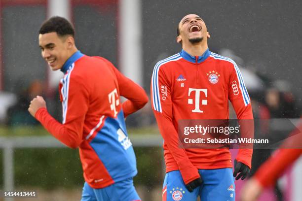 Jamal Musiala and Leroy Sane of FC Bayern München share a laugh during a training session at Saebener Strasse training ground on January 05, 2023 in...