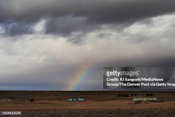 Rainbow is seen above homes in the Navajo Nation, on January 1, 2023 in Bitter Springs, Arizona. Reports say that nearly 40% of Navajo Nation is...