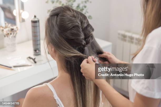 close up of a hairdresser combing, cutting and straightening the client's hair. hairdressing session. - quarantine wedding stock pictures, royalty-free photos & images