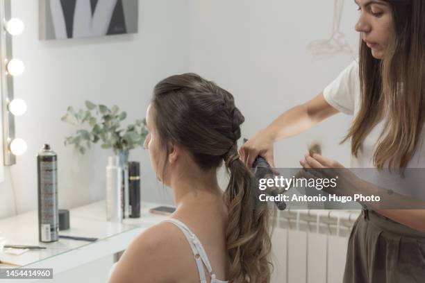 hairdresser combing, cutting and straightening the client's hair. hairdressing session. - quarantine wedding stock pictures, royalty-free photos & images