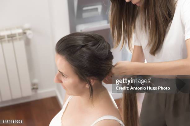 close up of a hairdresser combing, cutting and straightening the client's hair. hairdressing session. - quarantine wedding stock pictures, royalty-free photos & images