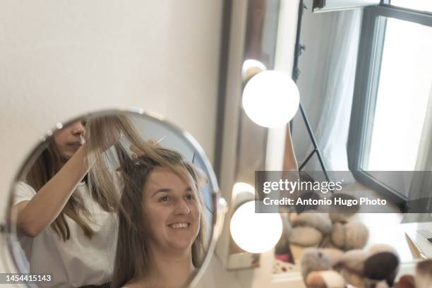 hairdresser combing, cutting and straightening the client's hair. hairdressing session. - quarantine wedding stock pictures, royalty-free photos & images