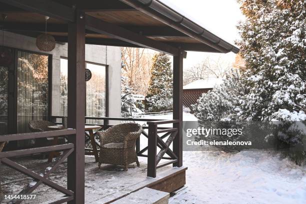 snow covered trees in the backyard garden - terrace stockfoto's en -beelden