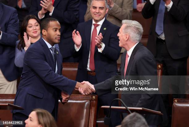 House Republican Leader Kevin McCarthy shakes hands with Rep.-elect John James in the House Chamber during the third day of elections for Speaker of...