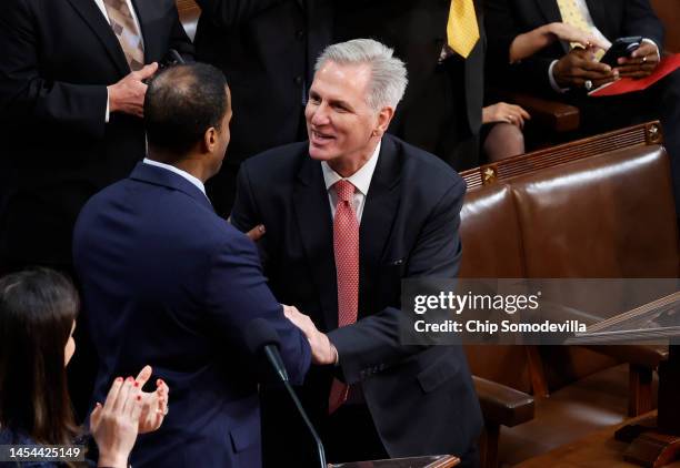 House Republican Leader Kevin McCarthy shakes hands with Rep.-elect John James in the House Chamber during the third day of elections for Speaker of...
