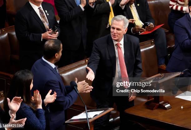 House Republican Leader Kevin McCarthy shakes hands with Rep.-elect John James in the House Chamber during the third day of elections for Speaker of...