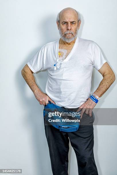 senior man wearing portable cancer chemotherapy pump - hospital identification bracelet stock pictures, royalty-free photos & images