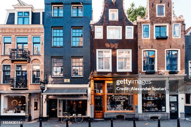 amsterdam street with small shops and cafes, holland, netherlands - exterior of amsterdam coffeeshop stock pictures, royalty-free photos & images