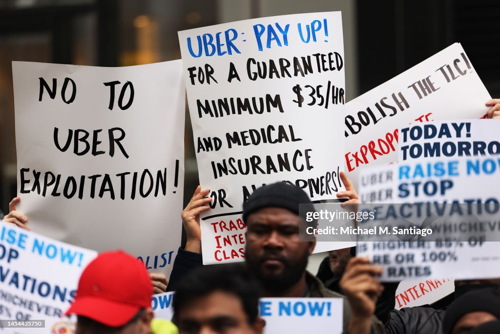 Uber drivers participate in a rally outside of the Uber Headquarters ...