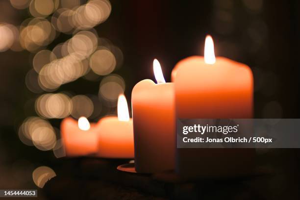 close-up of illuminated candles on table,germany - vela encendida fotografías e imágenes de stock