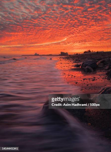scenic view of sea against dramatic sky during sunset,muscat,oman - grande mascate imagens e fotografias de stock