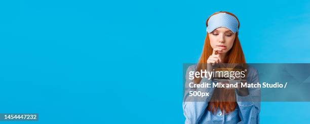 indecisive redhead girl cant resist temptation,biting finger and - temptation stock pictures, royalty-free photos & images