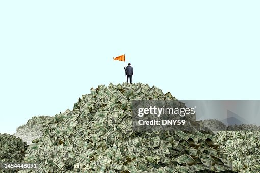 Man Planting Flag On Piles Of Cash