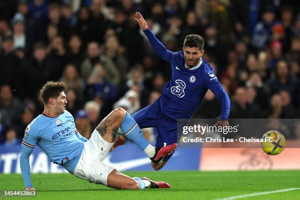 Christian Pulisic of Chelsea is challenged by John Stones of Manchester City, shortly before receiving medical treatment and leaving the field after...
