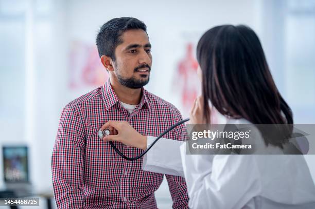 female doctor with a patient - doctor stethoscope patient whole body stock pictures, royalty-free photos & images