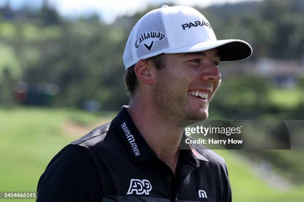 Sam Burns of the United States smiles after making birdie on the first green during the first round of the Sentry Tournament of Champions at...