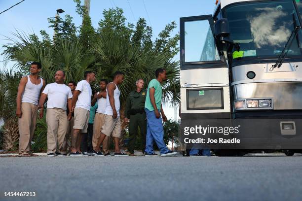 Migrants from Cuba line up to board a bus to be driven to a U.S. Customs and Border Protection station as they are processed on January 05, 2023 in...