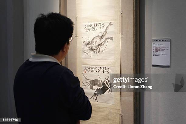 Visitor views "Cvabs and Shrimps" by Xu Beihong in the 2012 Poly Spring Auction Exhibition at the National Agriculture Exhibition Centre on May 30,...