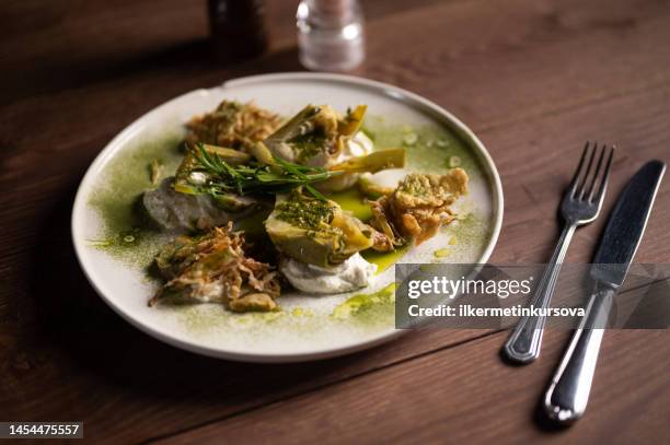 a plate of artichoke - artichoke stock pictures, royalty-free photos & images