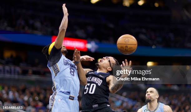 Cole Anthony of the Orlando Magic is fouled by Ziaire Williams of the Memphis Grizzlies during a game at Amway Center on January 05, 2023 in Orlando,...