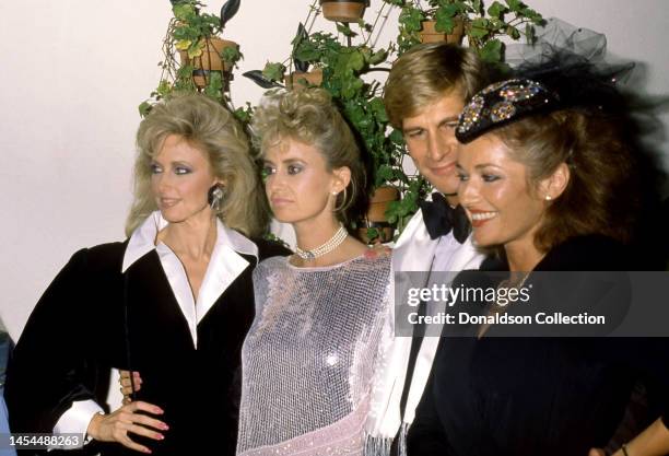 Morgan Fairchild, Susan George, Simon MacCorkindale and Stephanie Beacham pose for a portrait at an event, Los Angeles, California, circa 1985.