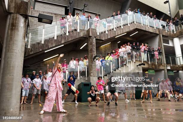 Spectators play an impromptu game of cricket behind the Victor Trumper Stand during a rain delay during day three of the Second Test match in the...