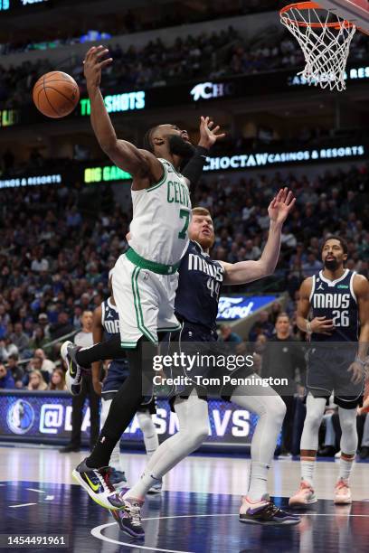 Jaylen Brown of the Boston Celtics draws the foul against Davis Bertans of the Dallas Mavericks in the first quarter at American Airlines Center on...